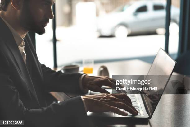 young man working on computer - procurar imagens e fotografias de stock