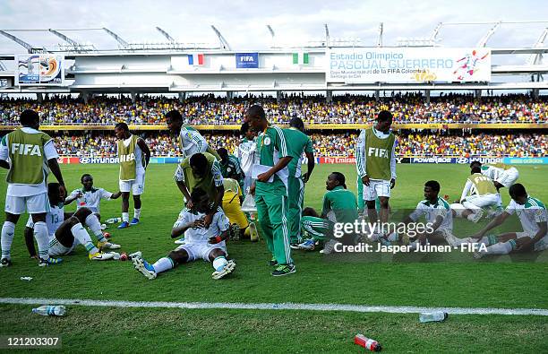 Nigeria players rest on the pitch prior to the start of extra timw during the FIFA U-20 World Cup Colombia 2011 quarter final match between France...