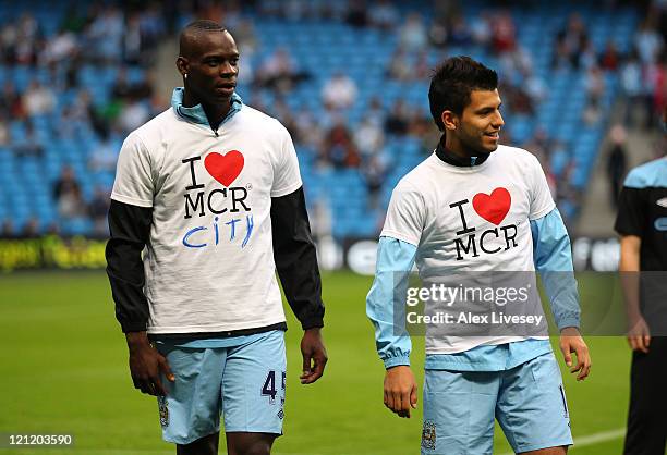 Mario Balotelli and Sergio Aguero of Manchester City warm up in a 'I love Manchester' T-shirts prior to the Barclays Premier League match between...