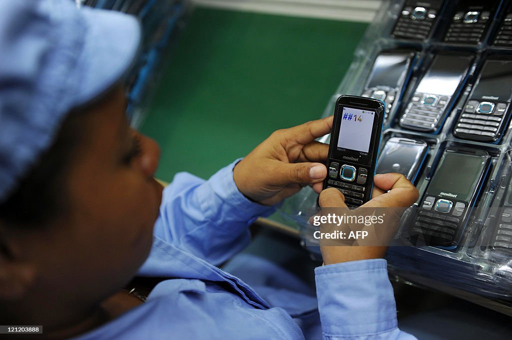 A worker tests cell phones made in China