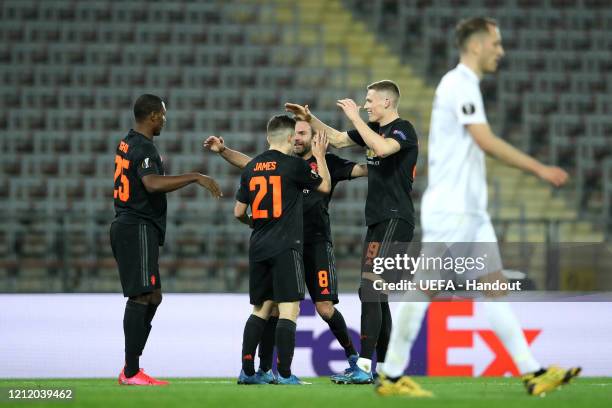 In this handout image provided by UEFA, Daniel James of Manchester United celebrates with Odion Ighalo, Juan Mata and Scott McTominay after scoring...