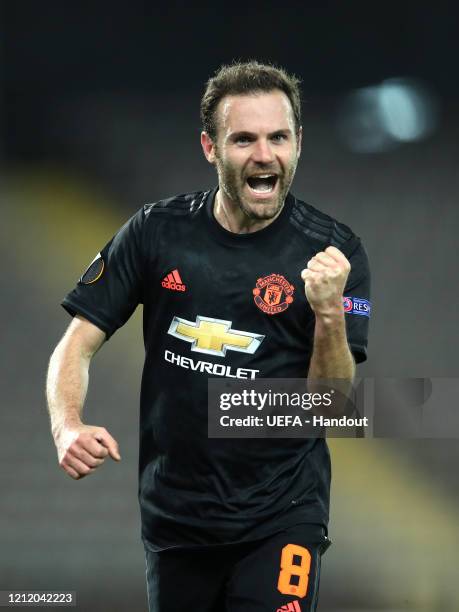 In this handout image provided by UEFA, Juan Mata of Manchester United celebrates after scoring his team's third goal during the UEFA Europa League...