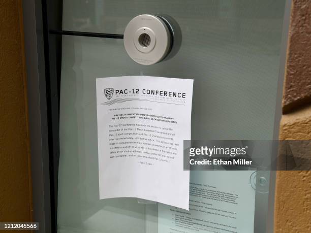 Note taped to a closed box office window informs fans of the cancellation of the Pac-12 Conference men's basketball tournament at T-Mobile Arena on...