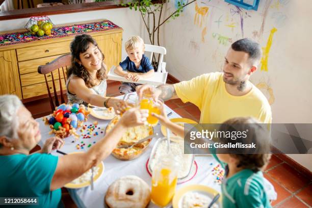 family celebrating an easter lunch in the dining table - happy easter mom stock pictures, royalty-free photos & images