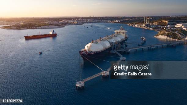 liquefied natural gas (lng) tanker moored to the jetty - estación edificio de transporte fotografías e imágenes de stock