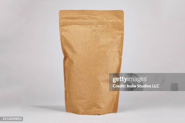 stand up brown paper zipper pouch centered in frame with space for copy - paper pouch stock pictures, royalty-free photos & images