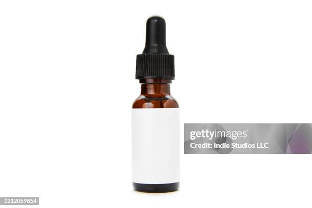 a single brown glass bottle with eyedropper lid sits on a pure white background with blank white label - pure white background bildbanksfoton och bilder