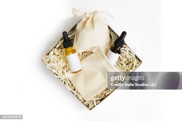 a cardboard box with two glass bottles and canvas bag sit on white background - cosmetics box stock pictures, royalty-free photos & images