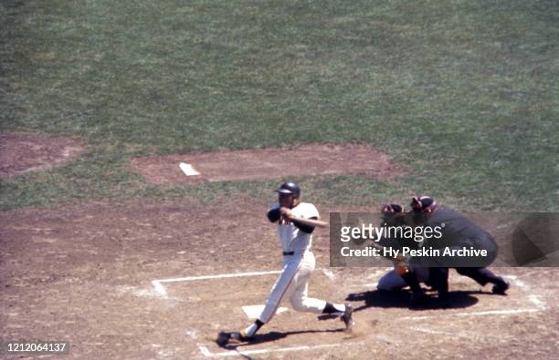 Willie Mays of the San Francisco Giants swings at the pitch as catcher Orlando McFarlane of the Pittsburgh Pirates and umpire Paul Pryor look on...