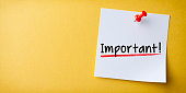 White Sticky Note With Important And Red Push Pin On Yellow Background
