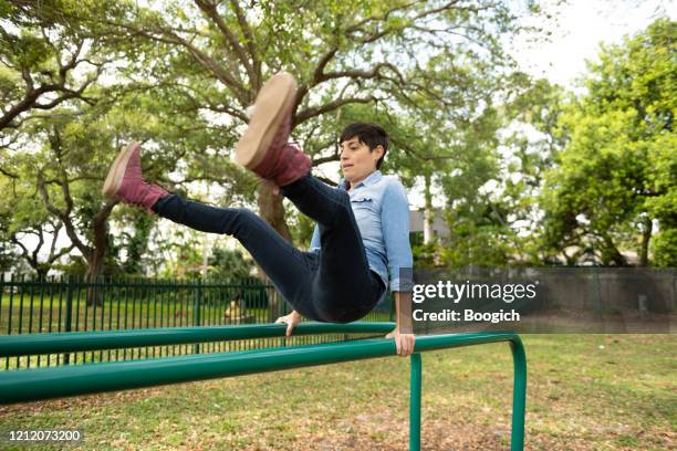 parkour enthusiast balancing on railing outdoors in miami neighborhood - transgender athlete stock pictures, royalty-free photos & images