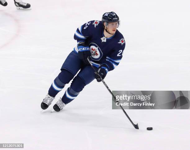 Cody Eakin of the Winnipeg Jets plays the puck down the ice during second period action against the Arizona Coyotes at the Bell MTS Place on March 9,...