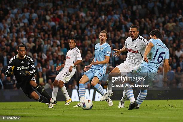 Sergio Aguero of Manchester City scores the second goal during the Barclays Premier League match between Manchester City and Swansea City at Etihad...