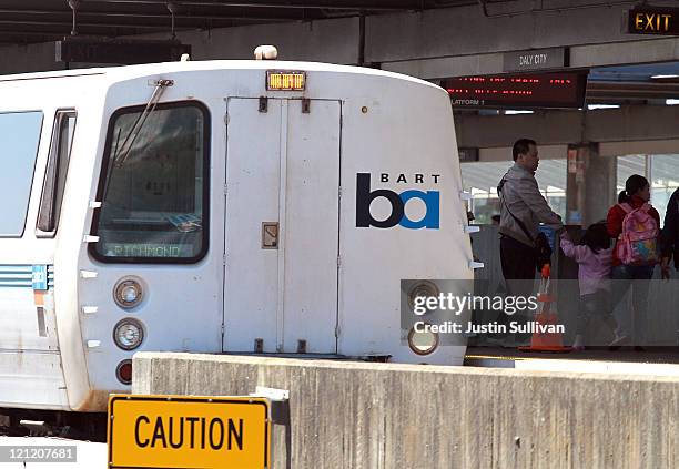 Passengers get off of a Bay Area Rapid Transit train as it arrives at the Daly City station on August 15, 2011 in Daly City, California. The hacker...