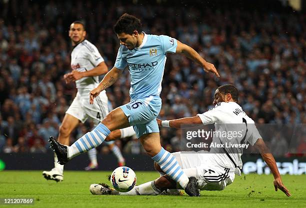 Sergio Aguero of Manchester City beats Ashley Williams of Swansea City during the Barclays Premier League match between Manchester City and Swansea...