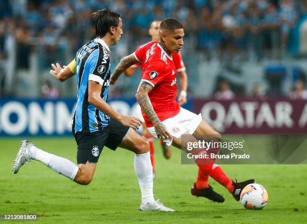 Pedro Geromel of Gremio and Paolo Guerrero of Internacional fight for the ball during the match for the Copa CONMEBOL Libertadores 2020 at Arena do...