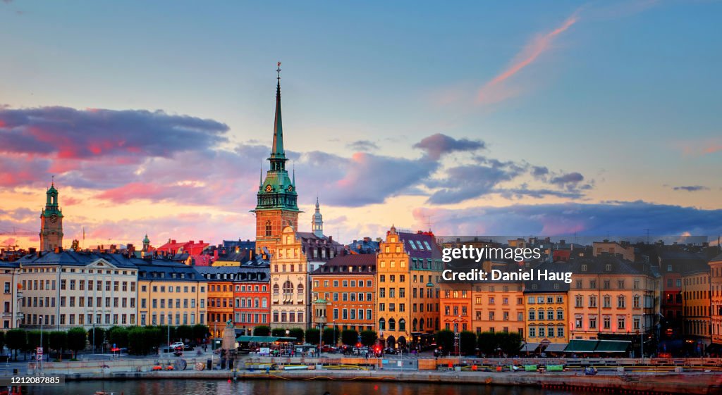 Colourful Swedish architecture reflecting golden sunset light after a long Scandinavian day