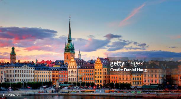 colourful swedish architecture reflecting golden sunset light after a long scandinavian day - stockholm imagens e fotografias de stock