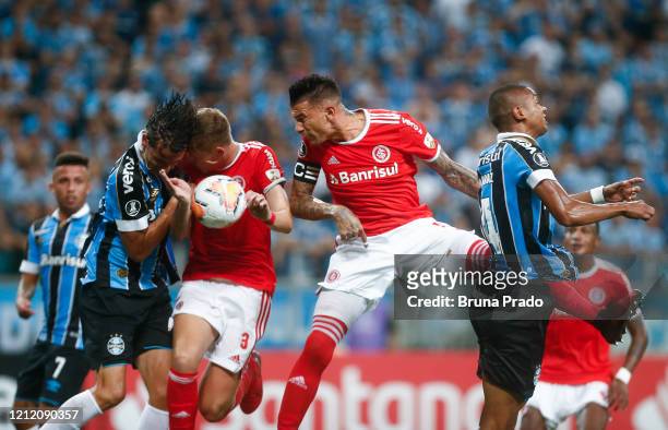 Pedro Geromel of Gremio, Bruno Fuchs and Victor Cuesta of internacional and David Braz of Gremio fight for the ball during the match for the Copa...