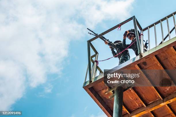 The sniper team occupied the commanding height to carry out reconnaissance and sniping on the target. Nanning, Guangxi, China, May 7, 2020.-