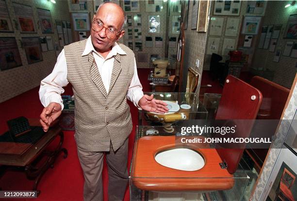 Curator of the Sulabh International Toilet Museum Mulk Raj gestures as he provides a guided tour of the museum's main exhibition hall 11 November....