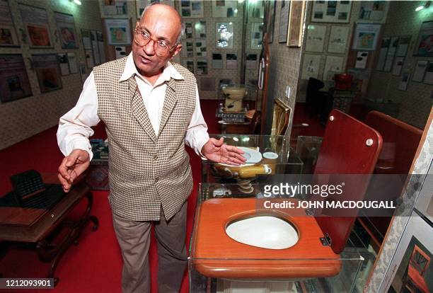 Curator of the Sulabh International Toilet Museum Mulk Raj gestures as he provides a guided tour of the museum's main exhibition hall 11 November....