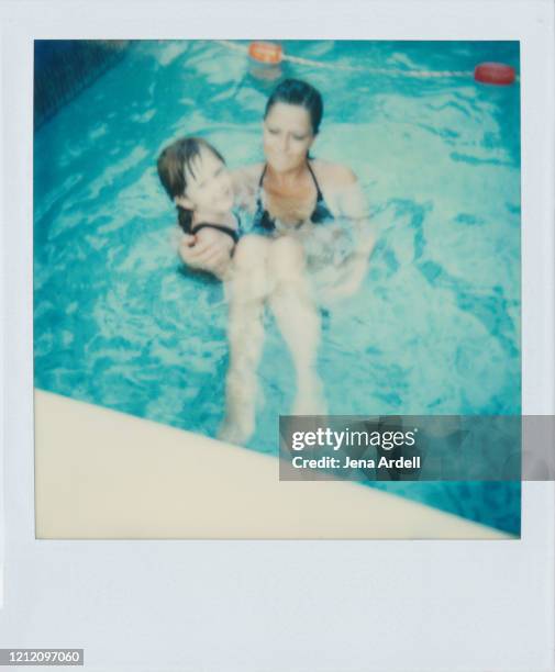 role reversal: mother and daughter playing in swimming pool, family togetherness care - women swimming pool retro stock pictures, royalty-free photos & images