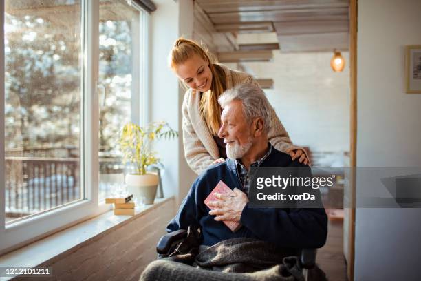 helping her old man - wheelchair stock pictures, royalty-free photos & images