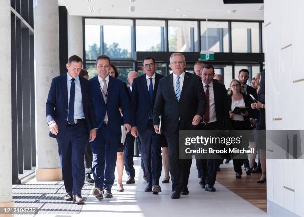 Prime Minister Scott Morrison is flanked by State and Territory leaders as they arrive for a press conference during which the announcement was made...