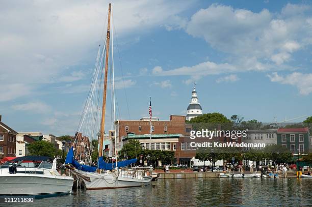 view of boats by the annapolis harbor and the city - annapolis stock pictures, royalty-free photos & images