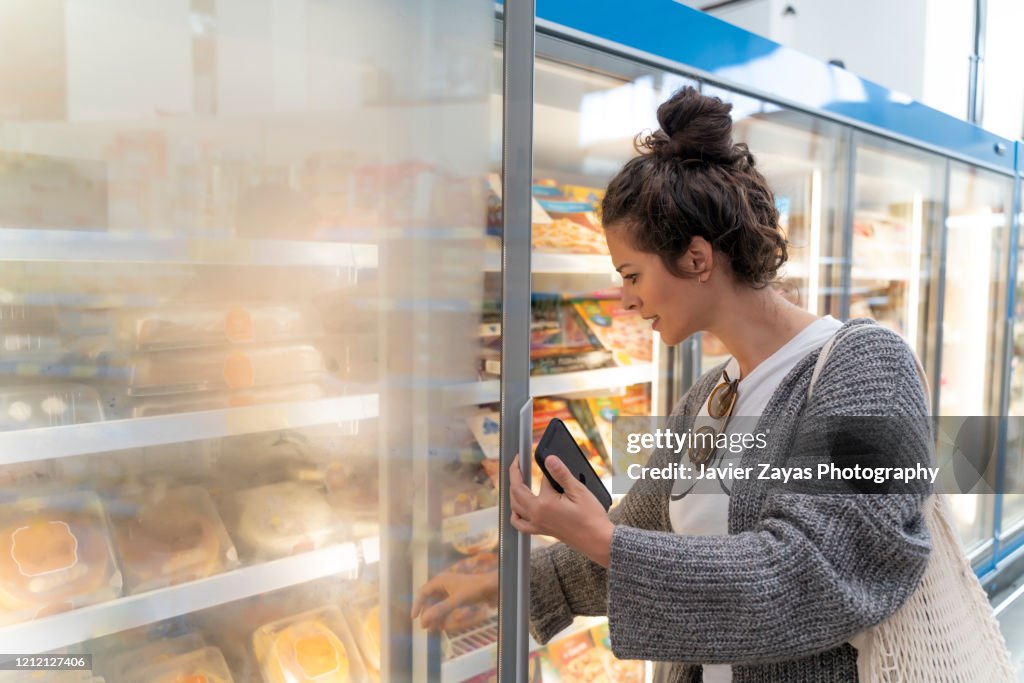 Young Women In Supermarket Grocery Shopping