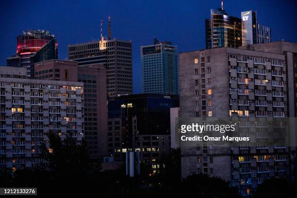 Apartment building lights shine throught windows at late evening during the Coronavirus Covid-19 epidemic on May 06, 2020 in Warsaw, Poland. Poland...