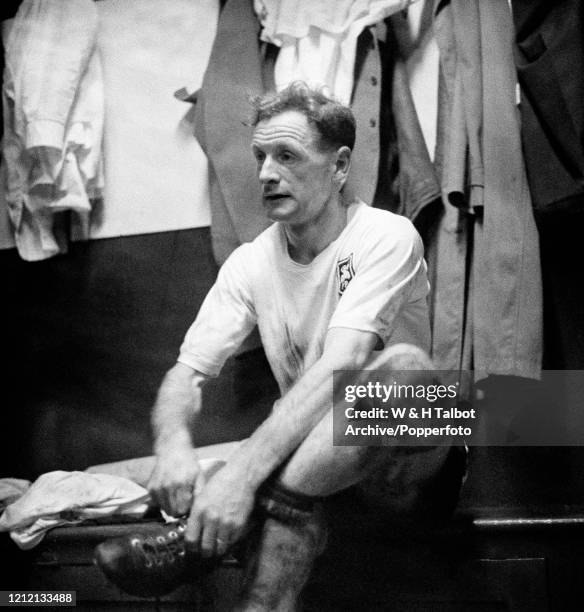 Tom Finney of Preston North End removes his boots in the changing room after the Football League Division One match between Preston North End and...