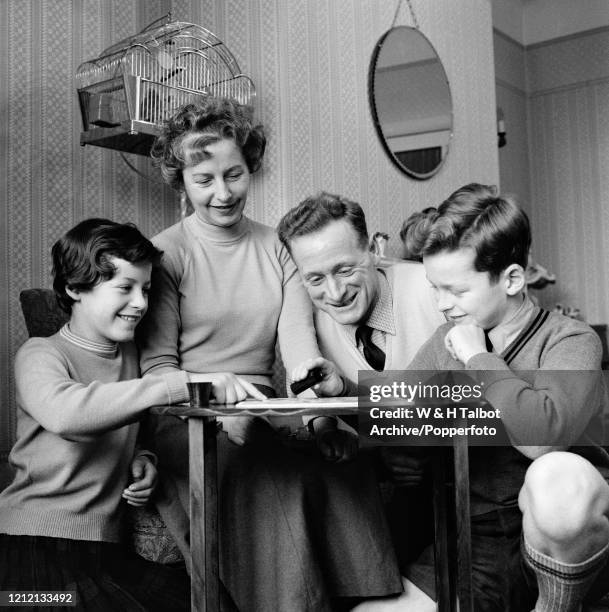 Preston North End and England footballer Tom Finney enjoys a board game at home with his wife Elsie and two children Barbara and Brian in Preston,...