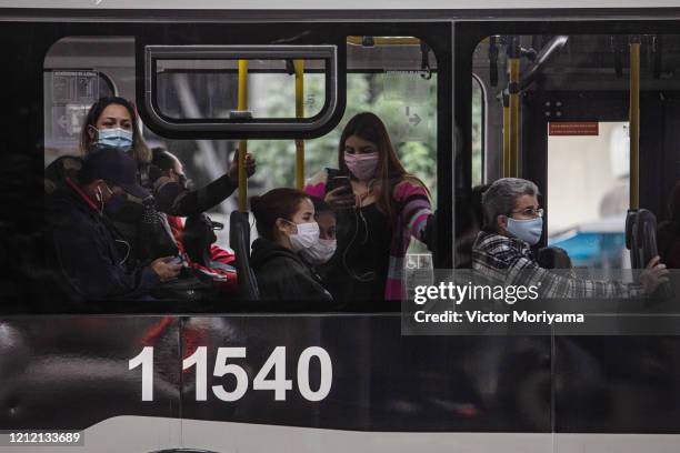 Commuters ride the bus wearing face masks on May 7, 2020 in Sao Paulo, Brazil. The Government of the State of São Paulo has decreed the mandatory use...