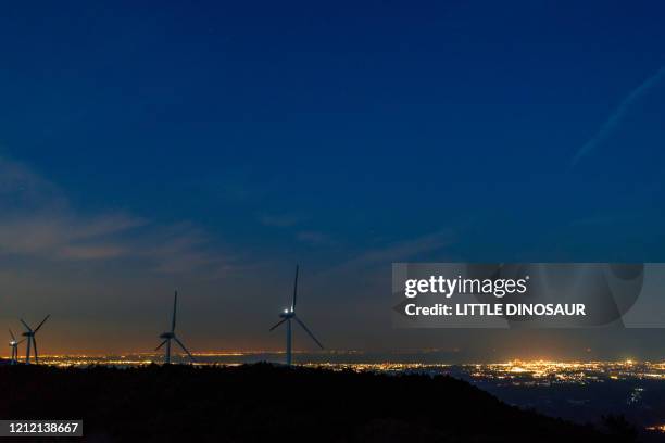 night view. wind generators and city lights - tokai region stock-fotos und bilder