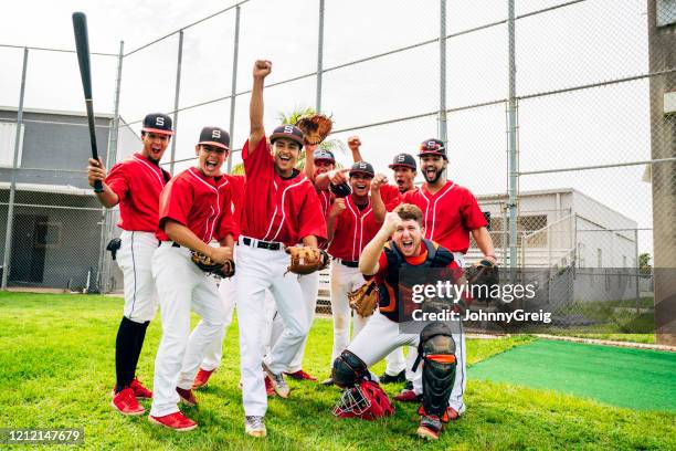 portrait of hispanic baseball teammates celebrating success - teen baseball team stock pictures, royalty-free photos & images