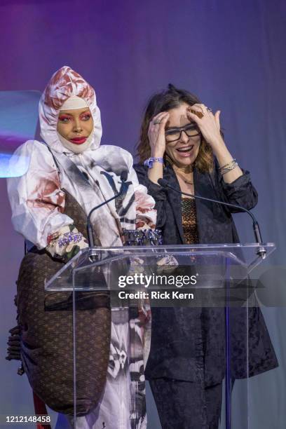 Honoree Erykah Badu accepts an award from host Parker Posey at the Austin Film Society's Texas Film Awards 20th Anniversary at Austin Studios on...