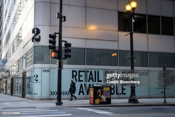 Pedestrian passes an available retail space in Chicago, Illinois, U.S., on Thursday, May 7, 2020. Governor Pritzker extended the state's stay-at-home...