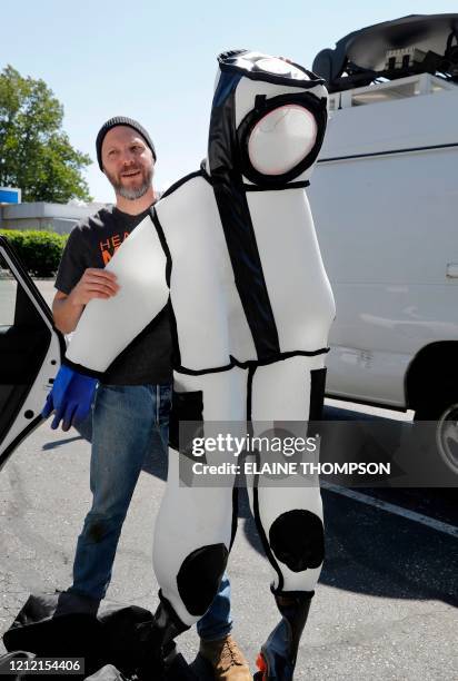 Washington State Department of Agriculture entomologist Chris Looney displays a suit bought for the department specifically to wear when...