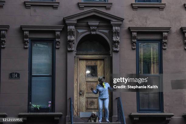 Resident living under lockdown rules dances on their stoop to celebrate medical workers on May 7, 2020 in the Clinton Hill neighborhood in the...
