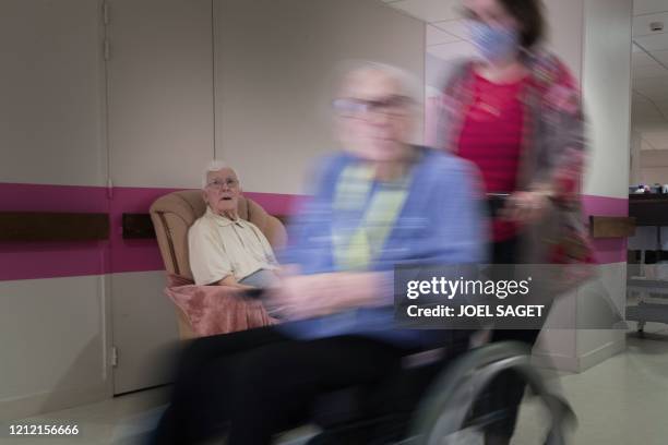 Resident leaves a room after doing activities at the Camille Saint-Saens EHPAD in Aulnay-sous-Bois, a Paris suburb, on May 6 on the 51st day of a...