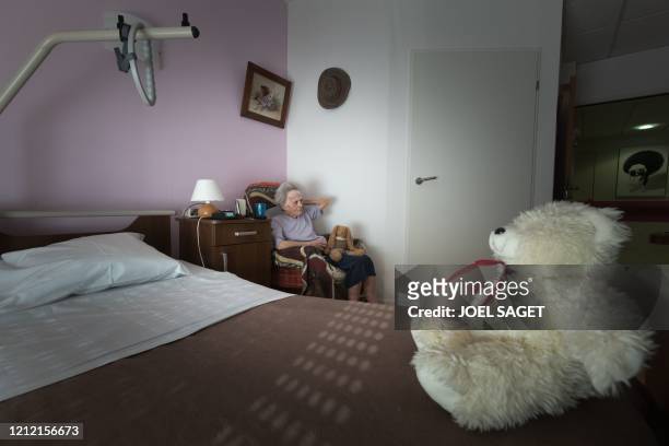 Nicole Muller watches televison in her bedroom at the Camille Saint-Saens EHPAD in Aulnay-sous-Bois, a Paris suburb, on May 6 on the 51st day of a...