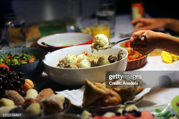 Foods are displayed on the table while a Muslim family eat fast-breaking dinner during the holy month Ramadan in east London, United Kingdom on May...