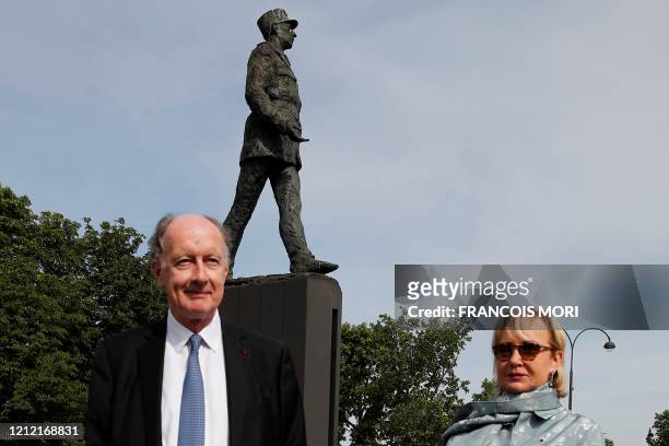 Yves de Gaulle, a grand-son of Charles de Gaulle, and his wife Laurence, pose in front of the statue of General Charles de Gaulle ahead of the start...