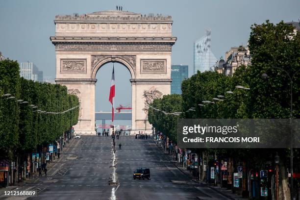 The empty Champs Elysee avenue and the Arc de Triomphe are pictured before VE Day ceremonies on May 8, 2020 in Paris. - The 75th anniversary of the...