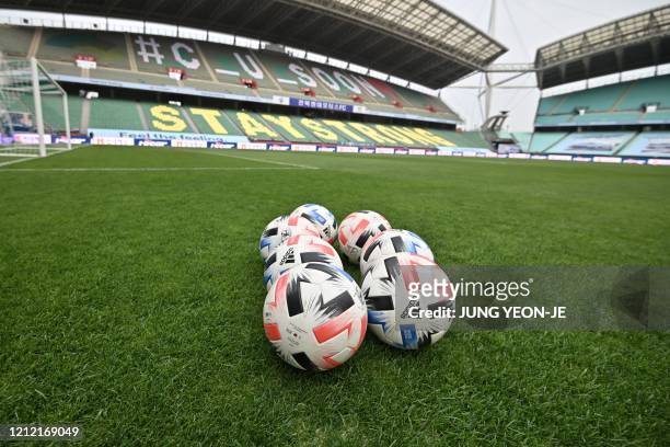 Soccer balls are seen on the ground prior to the opening game of South Korea's K-League football match between Jeonbuk Hyundai Motors and Suwon...