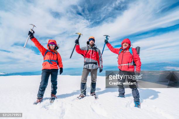 de berg bergklimploeg houdt ijsbijl in de piek van hoogteberg in de winter - ice pick stockfoto's en -beelden