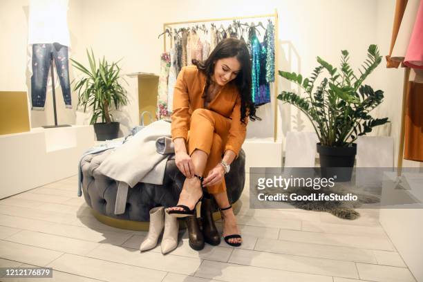 young woman trying shoes on - footwear stock pictures, royalty-free photos & images