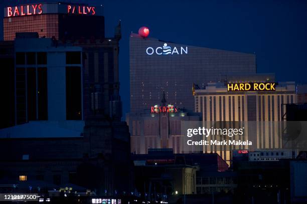 Bally's, Ocean, Resorts, and Hard Rock Casino are illuminated at dusk despite being shuttered during the coronavirus pandemic on May 7, 2020 in...
